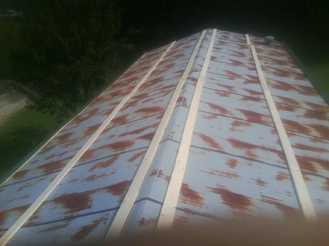 Rusted metal roof panels with new wood purlins before replacement — Storm Damage Roof Repair in Groveport by Roofing Brothers