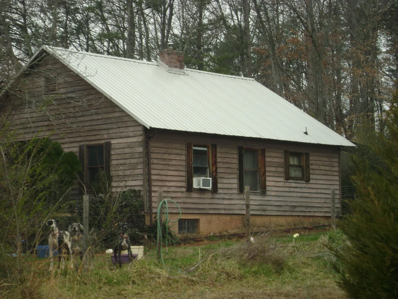 White metal roof on an old wood sided farmhouse, from a Metal Roof Installation job in Groveport